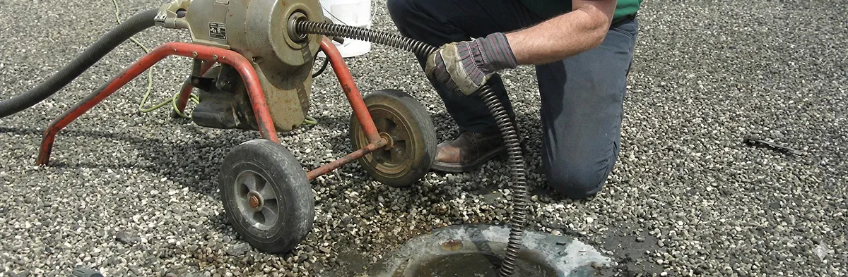 sewer rodding technician actively removing blockages from a sewer line in Charleston, SC